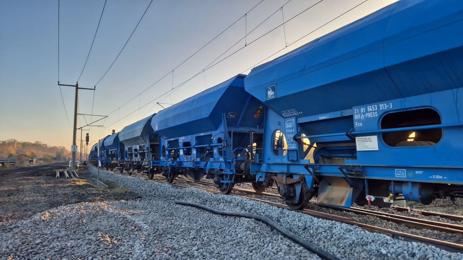 Rail construction crew working beside a track machine